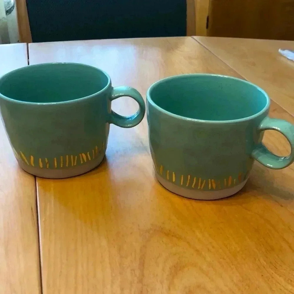 Set of two large mugs.  Speckled green with gold stripes.